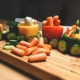 sliced carrots and green bell pepper on brown wooden chopping board