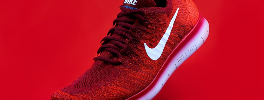 unpaired red Nike sneaker