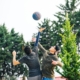 man in black t-shirt and black shorts playing soccer during daytime