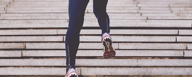 person climbing concrete stairs