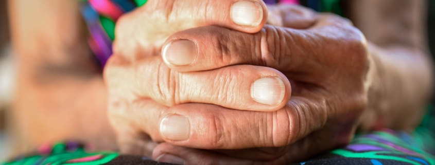 a close up of a person holding their hands together